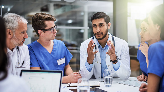 Doctors talking around a table